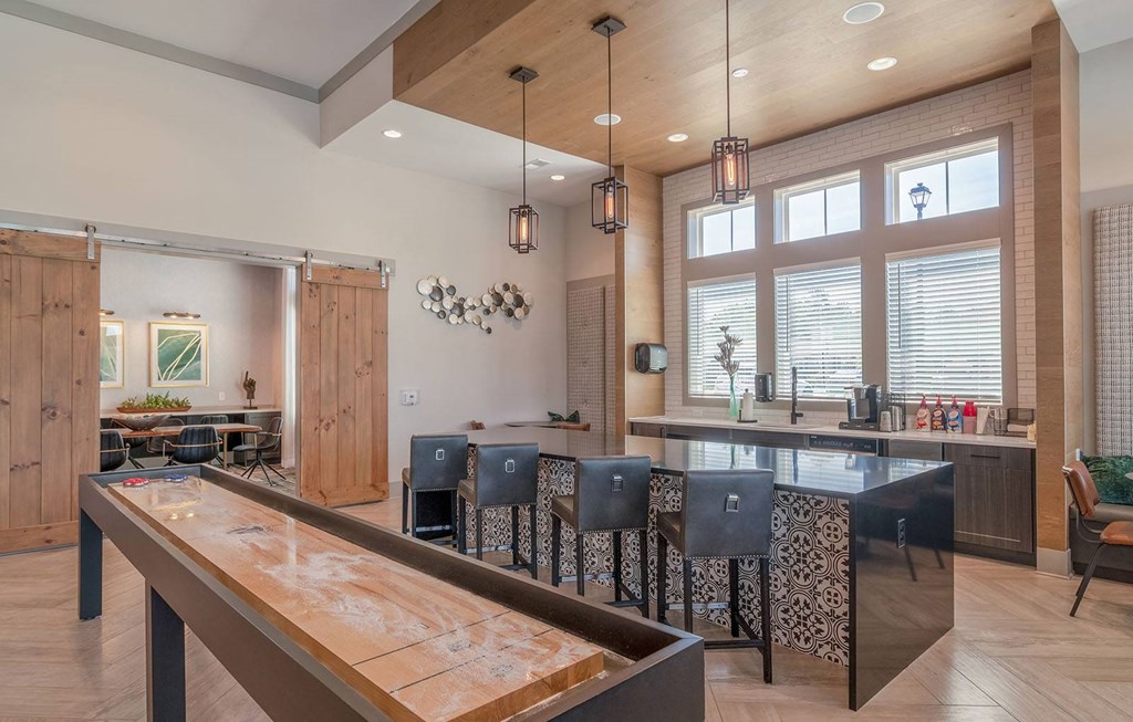 a large kitchen with a bar and a dining table at Carmel Vista, McDonough