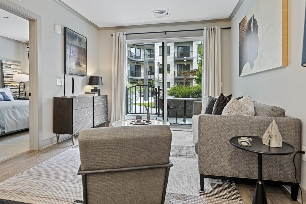 a living room with two couches and a coffee table in front of a sliding glass door at The Harrison, Newtown Square, 19073