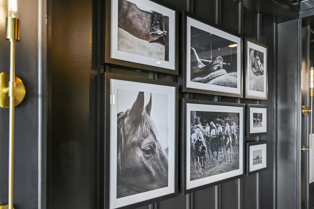 a row of framed photographs on a wall at The Harrison, Newtown Square, PA