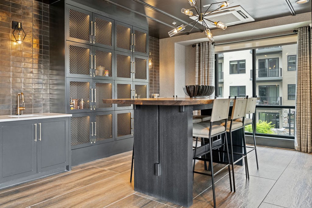 a kitchen with a large island and a bar with chairs at The Harrison, Newtown Square, Pennsylvania