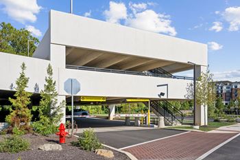a parking garage with a red fire hydrant in front of it at Madison West Elm, Conshohocken Pennsylvania