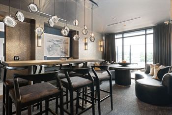 A modern dining room with a long table and chairs at Madison West Elm, Conshohocken