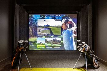 a display of golf equipment in front of a tv screen at Madison West Elm, Conshohocken, PA