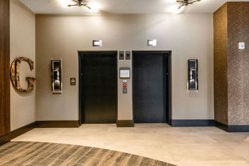 A hallway with two elevators and a large letter G on  at Madison West Elm, Conshohocken, PA 19428the wall
