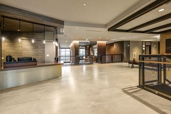 A spacious lobby with a reception desk and a large glass door at Madison West Elm, Conshohocken, 19428
