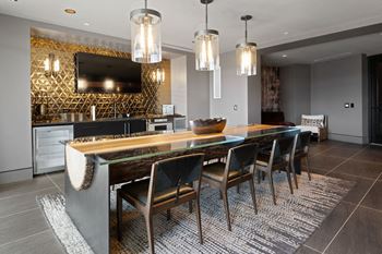 A modern dining room with a wooden table and chairs at Madison West Elm, Conshohocken