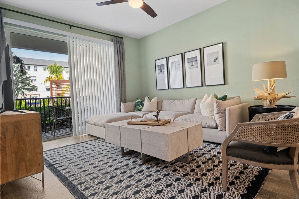 a living room with a couch and a table at Inspira, Naples, Florida