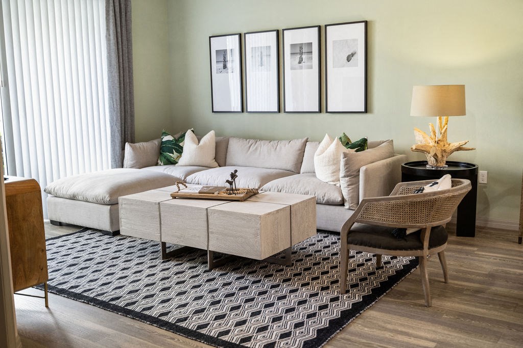 a living room with a couch and a table at Inspira, Naples, FL, 34113