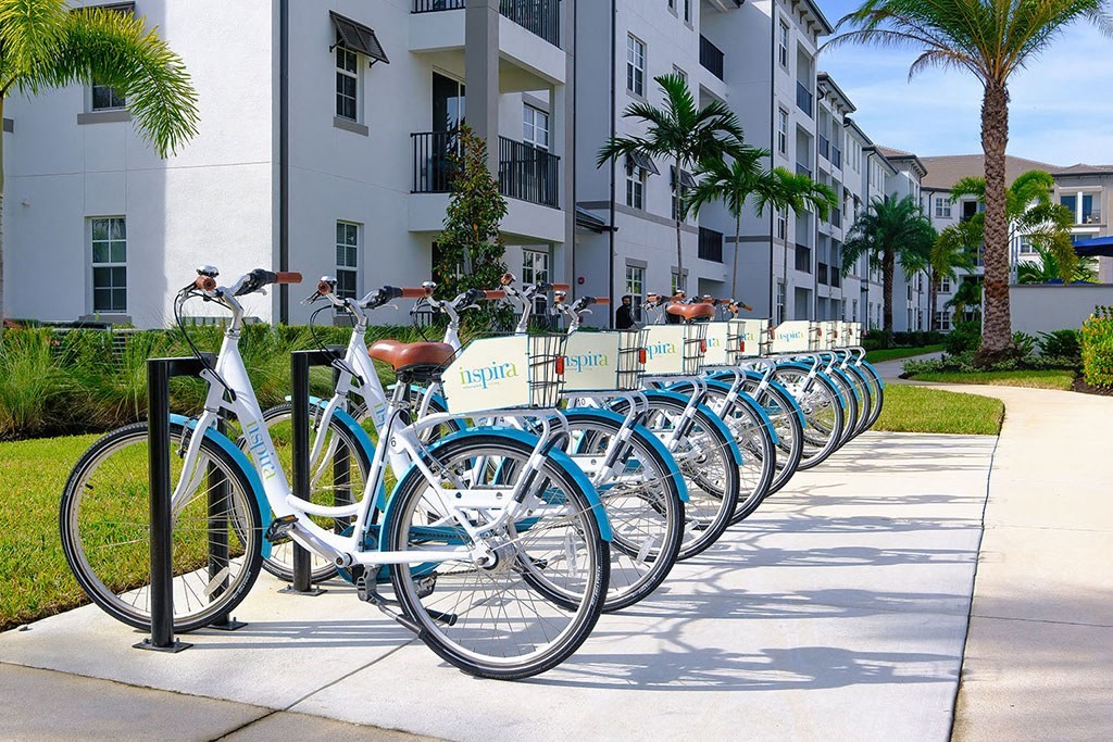 a row of bikes parked in front of an apartment building at Inspira, Naples, 34113