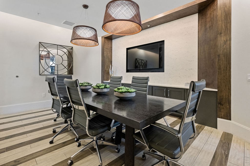 Conference table with TV for presentations available for use by residents at Inspira, Florida