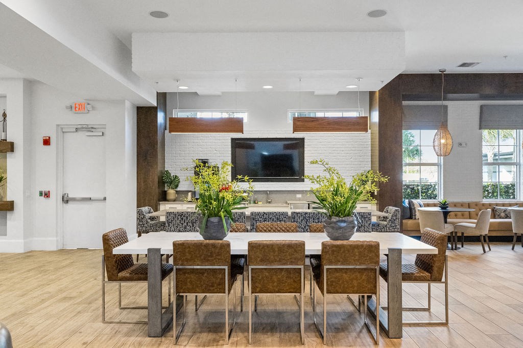 Large dining table for resident to gather, work from, eat and visit at Inspira, Naples, FL, 34113