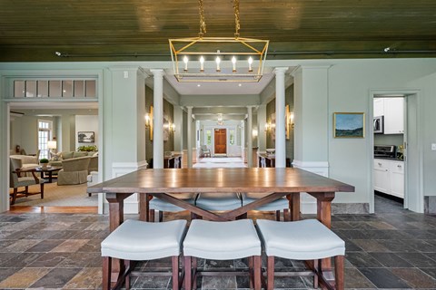 A dining room with a wooden table and chairs.