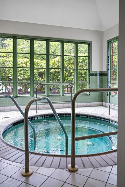 A small indoor pool with a metal railing.