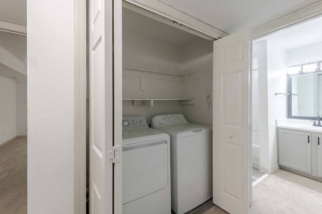 A small laundry room with a washer and dryer.