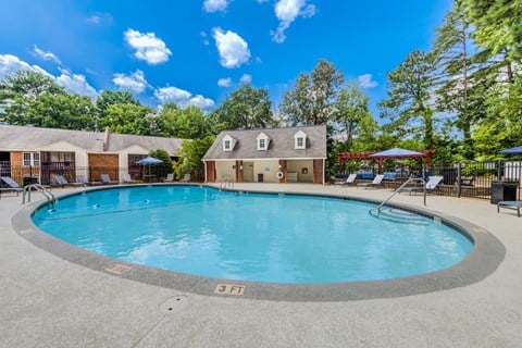 A swimming pool with chairs and umbrellas