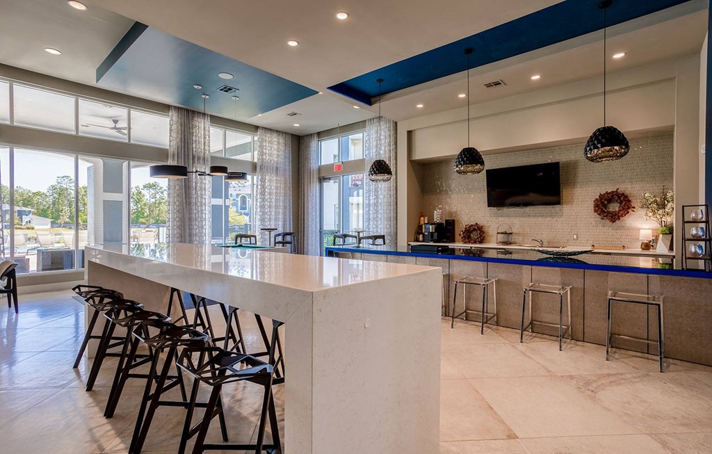the lobby of a restaurant with a bar and stools  at The Parkway on Westlake, Humble