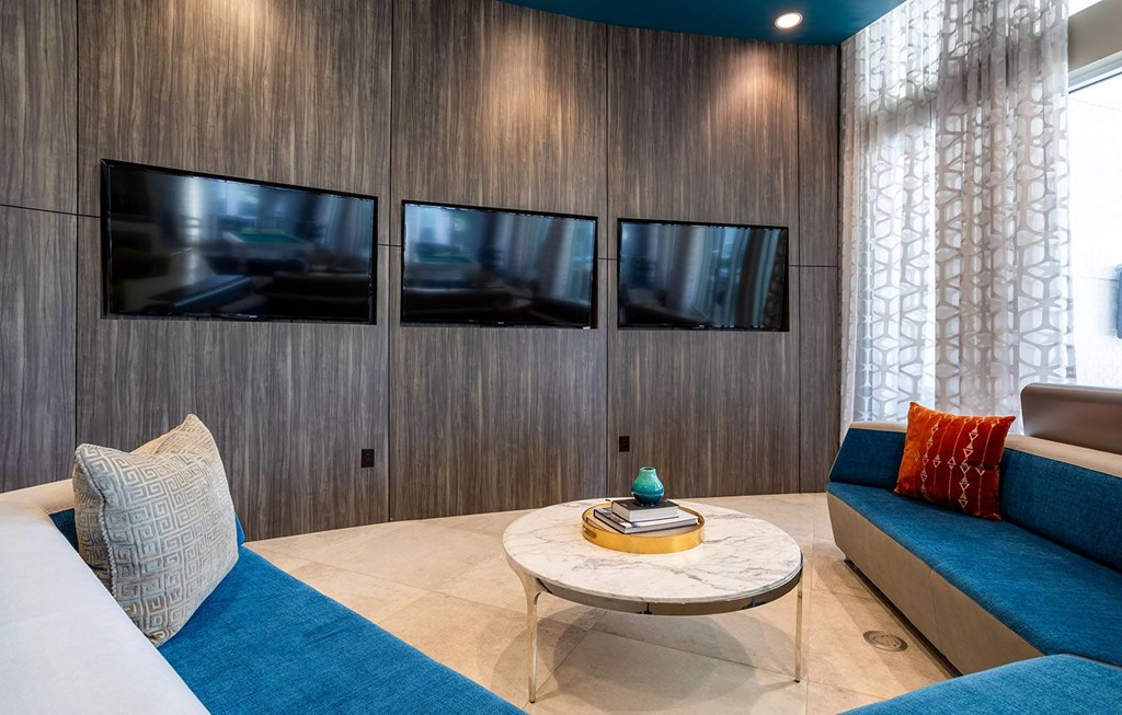 a living room with couches and a table  at The Parkway on Westlake, Humble, TX