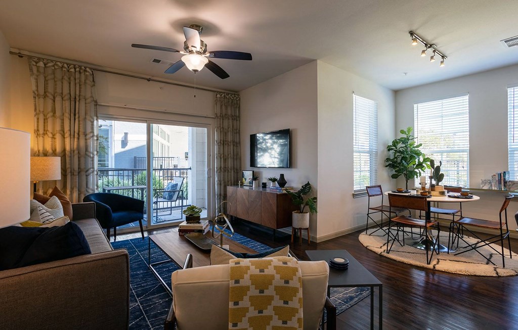 a living room with furniture and a ceiling fan at The Parkway on Westlake, Humble, TX
