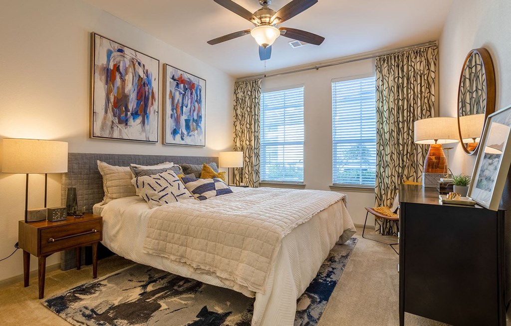 a bedroom with a bed and a ceiling fan a bedroom with a bed and a ceiling fan at The Parkway on Westlake, Humble, Texas