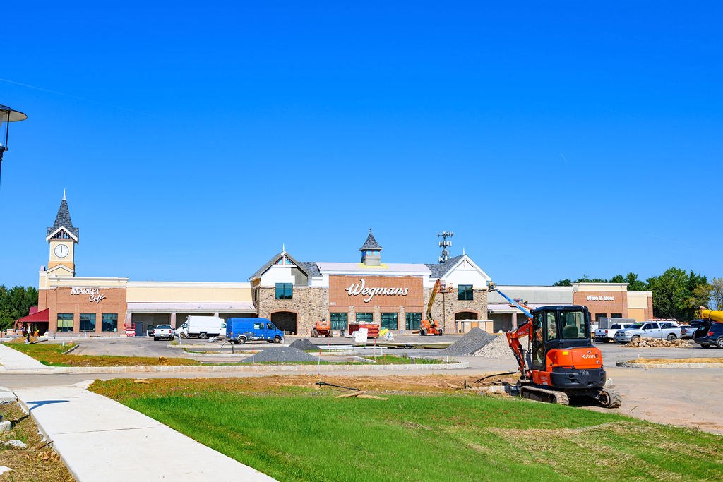 A construction vehicle is parked in front of a building with a sign that says "Wynn's." at Madison Prickett Preserve, Yardley, PA