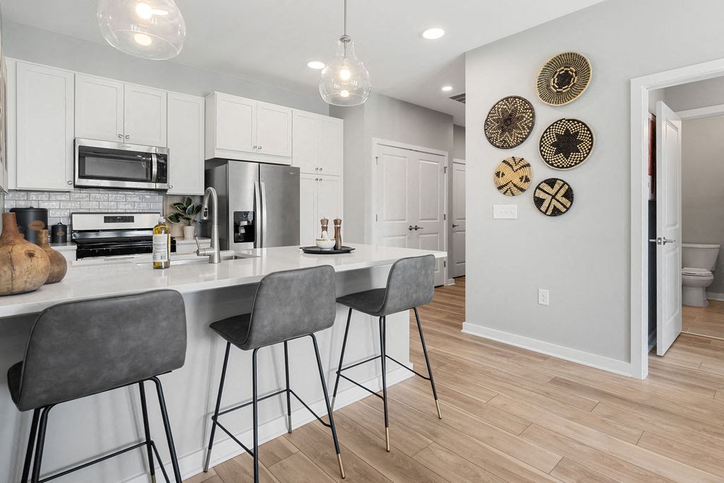A kitchen with a white counter top and grey bar stools at Madison Prickett Preserve, Pennsylvania