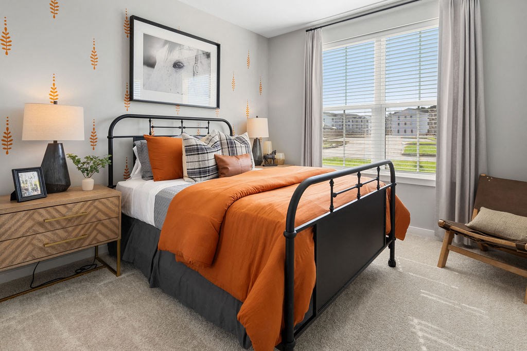 A bedroom with a large bed and a chair at Madison Prickett Preserve, Yardley, PA