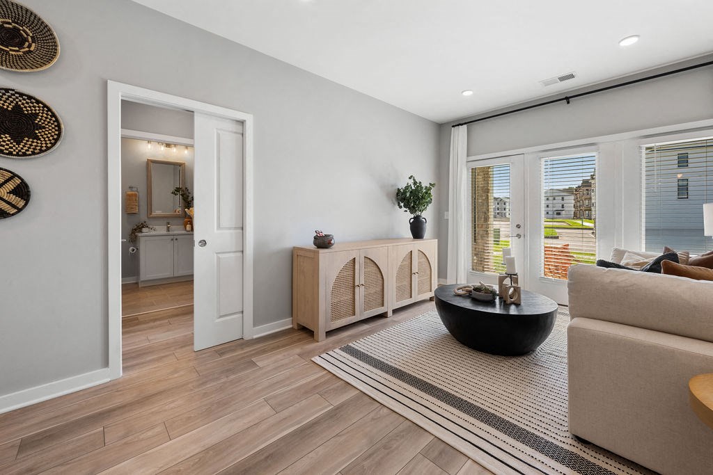 A modern living room with a wooden floor and a large window at Madison Prickett Preserve, Yardley Pennsylvania