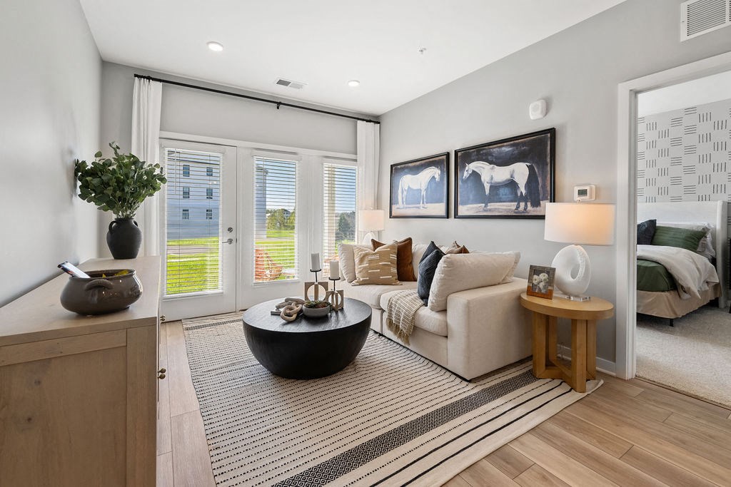 A modern living room with a large window and a view of a building outside at Madison Prickett Preserve, Pennsylvania