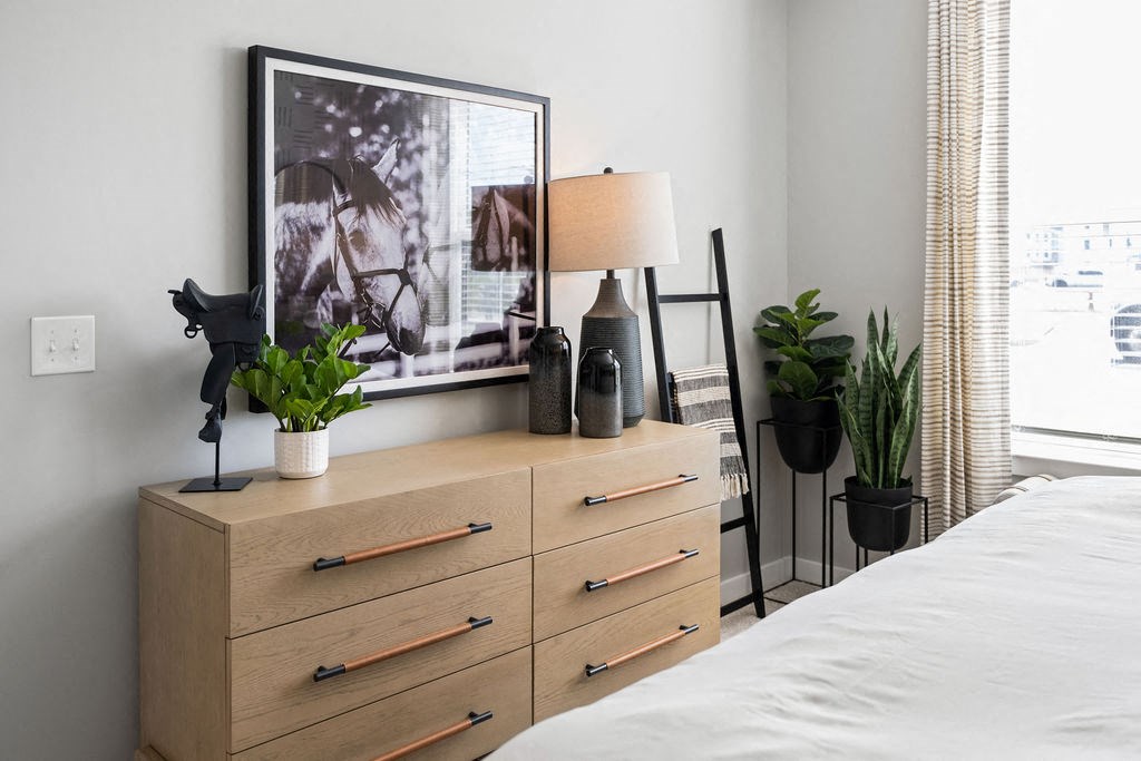 A bedroom with a bed, a dresser with a lamp and a framed picture on the wall at Madison Prickett Preserve, Yardley, 19067