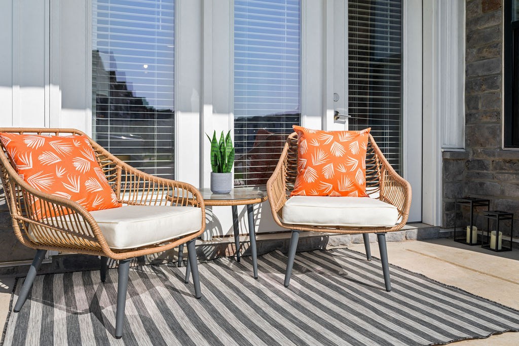 Two chairs with orange cushions are on a striped rug at Madison Prickett Preserve, Pennsylvania, 19067