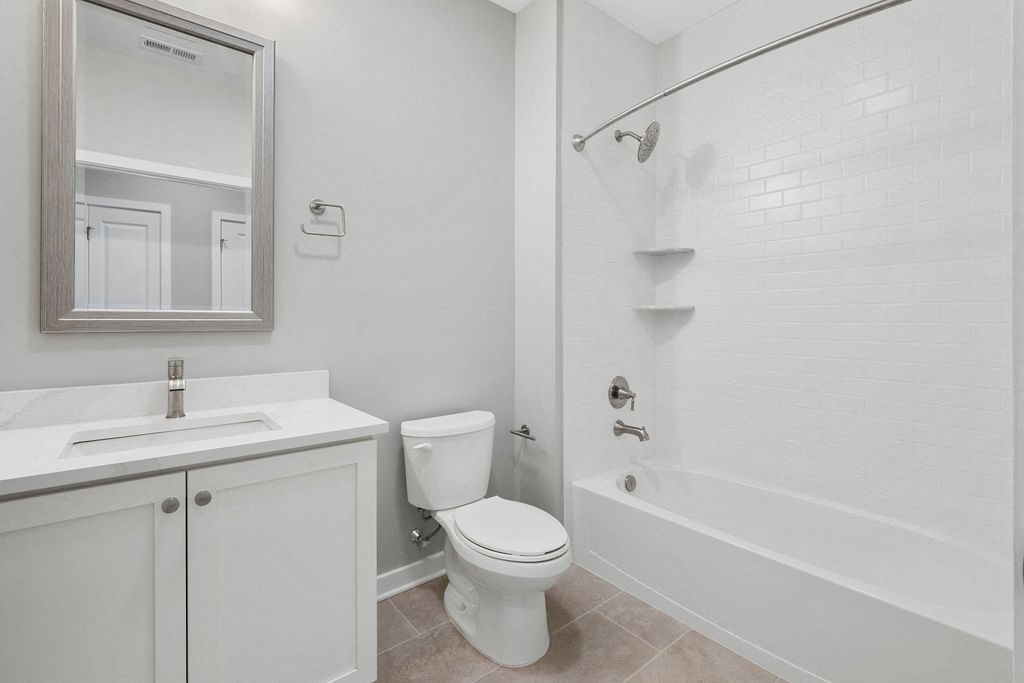 A white bathroom with a toilet, sink, and bathtub at Madison Prickett Preserve, Yardley