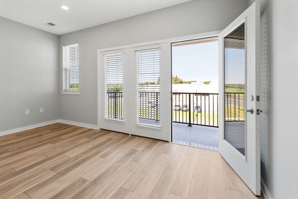 A room with a sliding glass door leading to a balcony at Madison Prickett Preserve, Yardley, PA