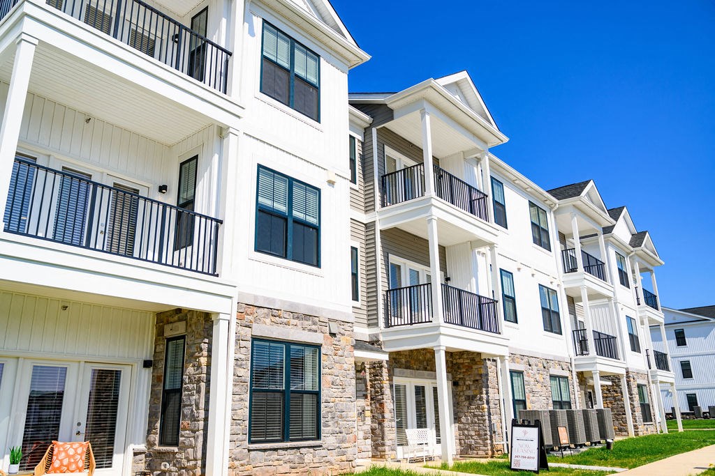 a row of apartments with balconies and a sidewalk at Madison Prickett Preserve, Yardley