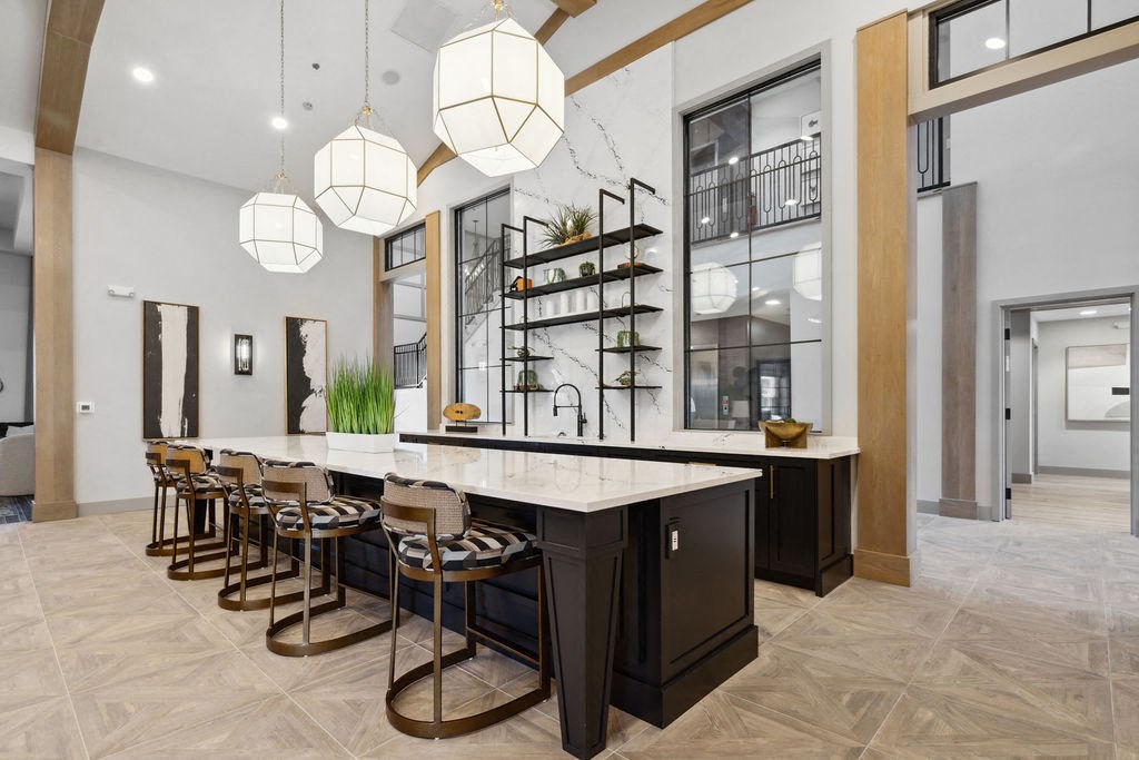 a large kitchen with a marble counter top and bar stools a large kitchen with a marble counter top and bar stools at Madison Prickett Preserve, Yardley, PA