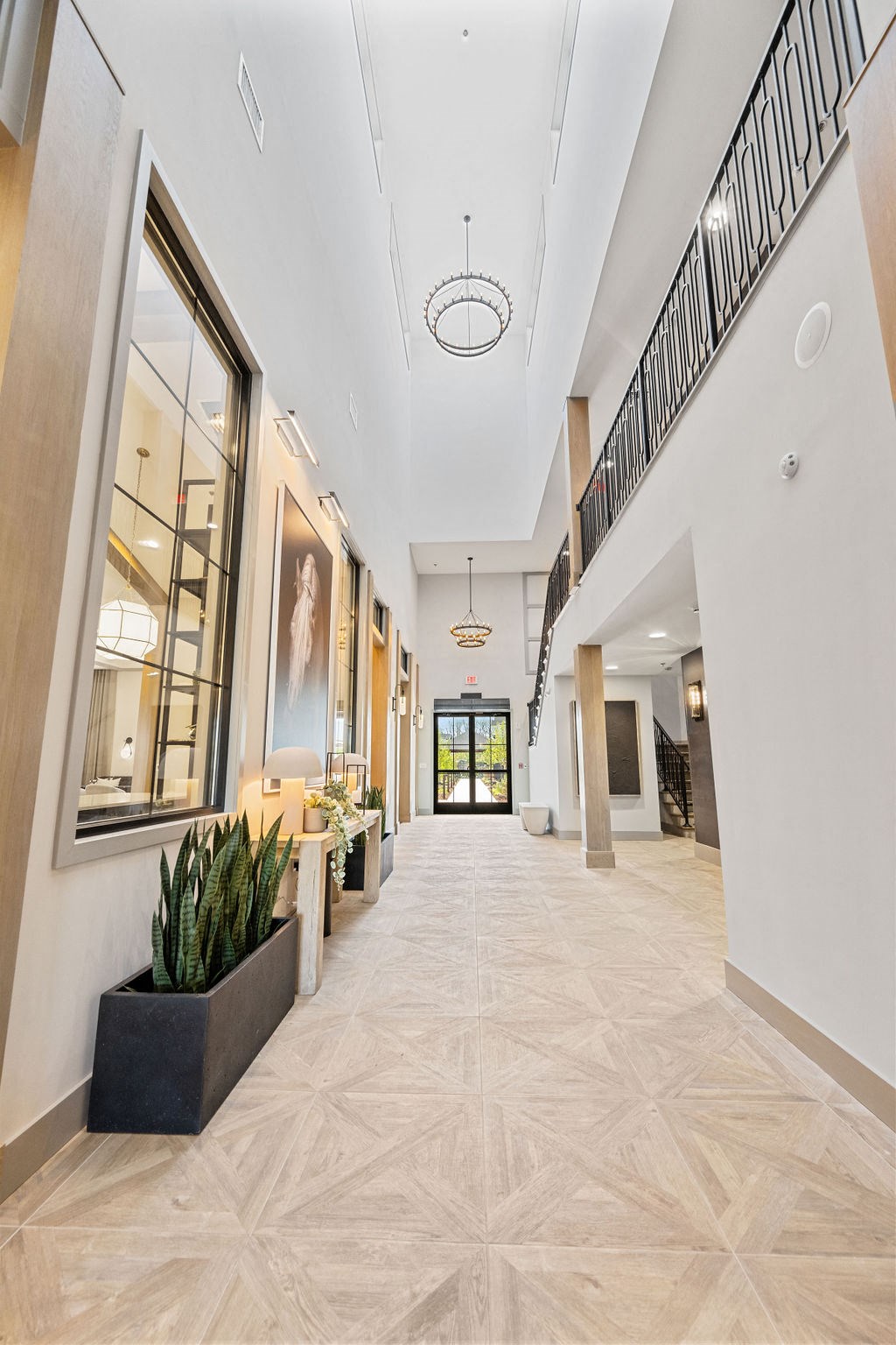 A long hallway with a plant on the left and a black railing on the right at Madison Prickett Preserve, Yardley, PA