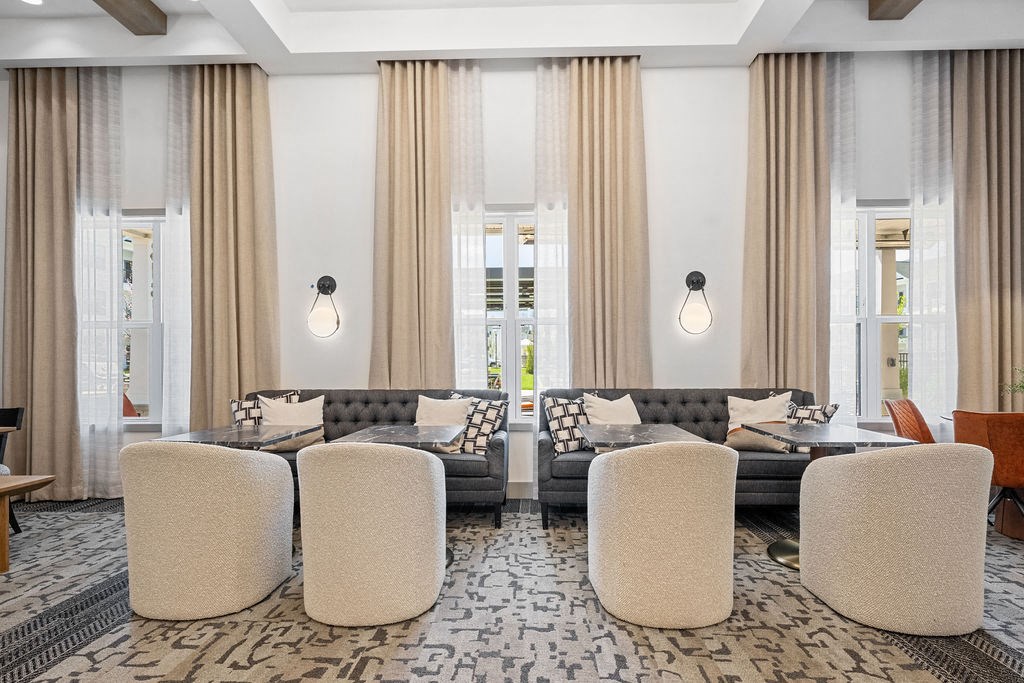 a lobby with chairs and tables and a geometric pattern on the wall at Madison Prickett Preserve, Yardley, 19067