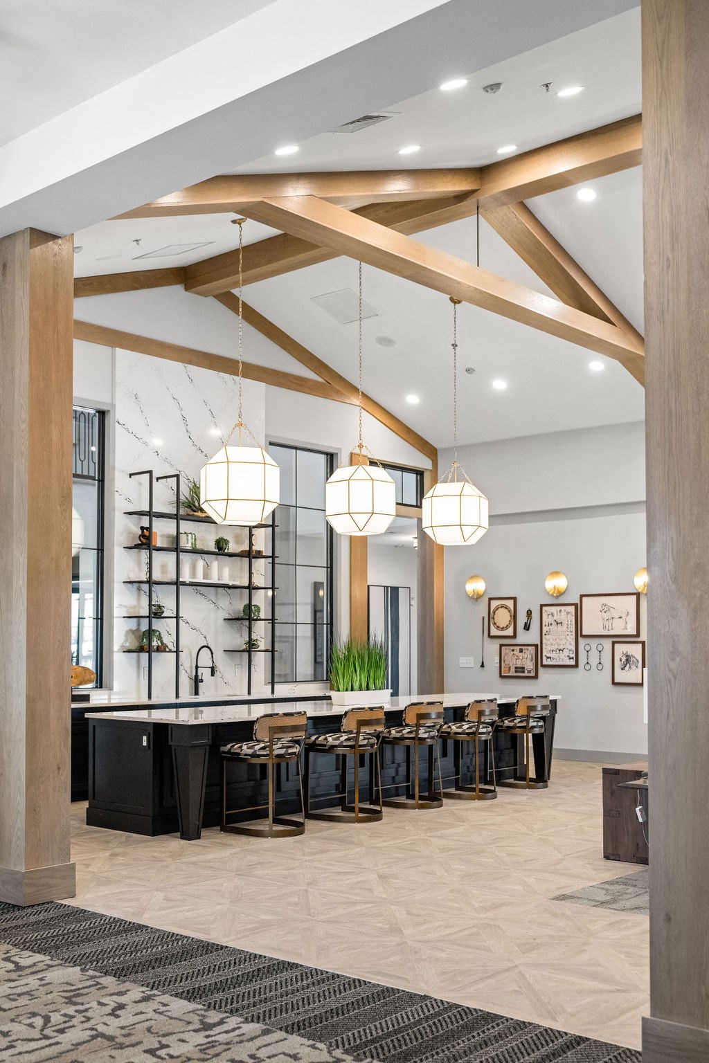 A modern kitchen with a black counter and wooden beams A modern kitchen with a black counter and wooden beams at Madison Prickett Preserve, Yardley