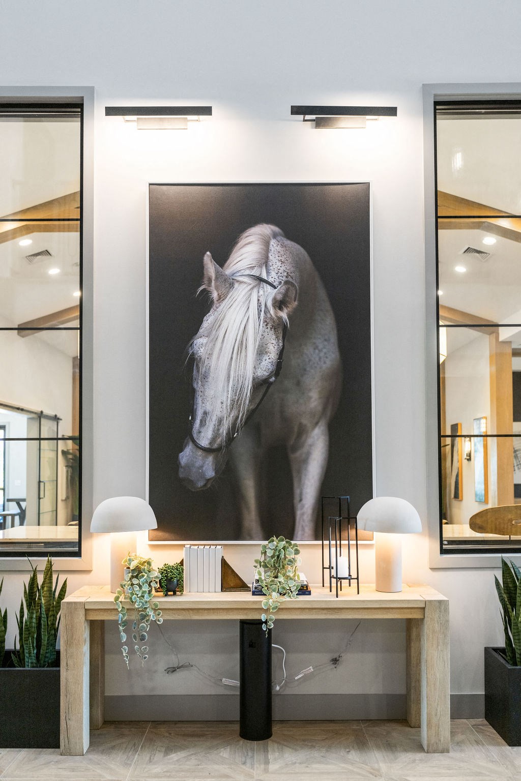 A large black and white photograph of a horse is displayed on a wall above a wooden table at Madison Prickett Preserve, Yardley, 19067