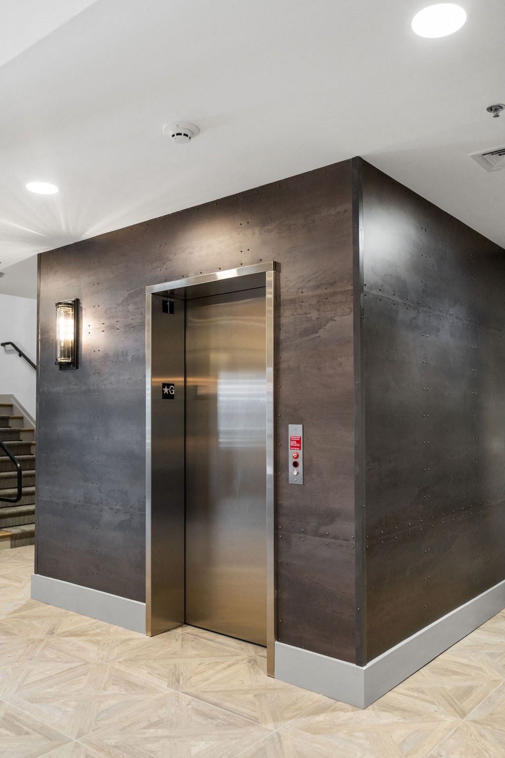 A stainless steel elevator with a red emergency stop button at Madison Prickett Preserve, Yardley Pennsylvania