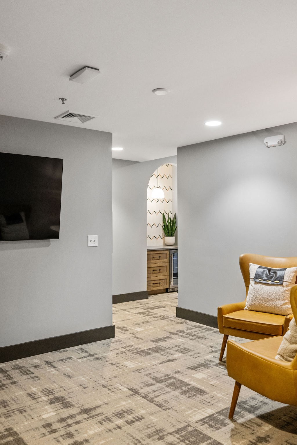a living room with yellow chairs and a television at Madison Prickett Preserve, Yardley, PA