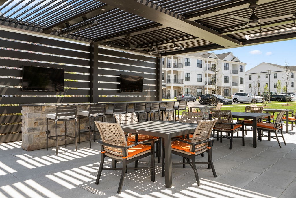 a patio with tables and chairs and a building in the background at Madison Prickett Preserve, Pennsylvania
