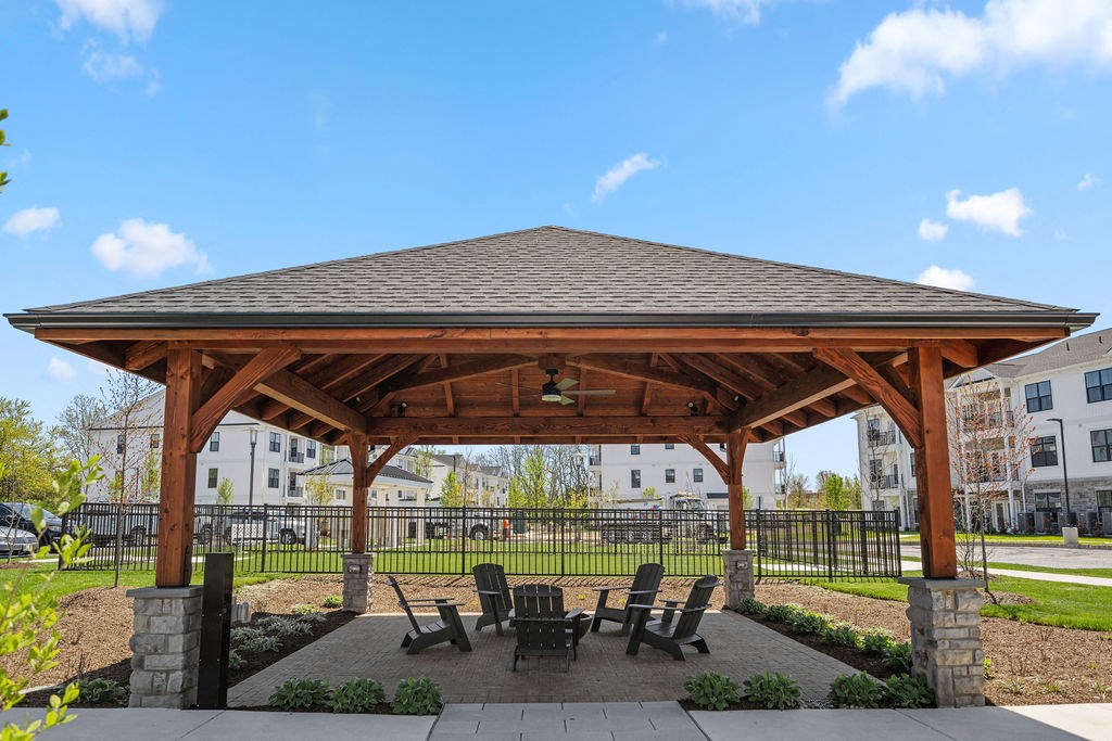 a pavilion with a table and chairs under it at Madison Prickett Preserve, Yardley