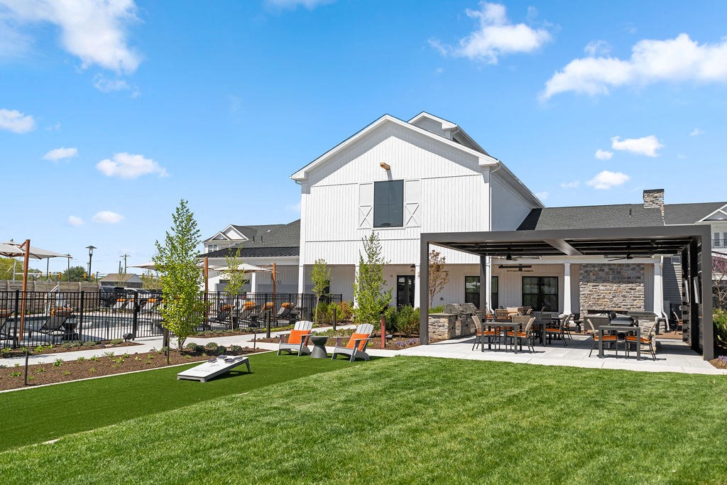 A white building with a black roof and a covered patio area with chairs and tables at Madison Prickett Preserve, Yardley, 19067