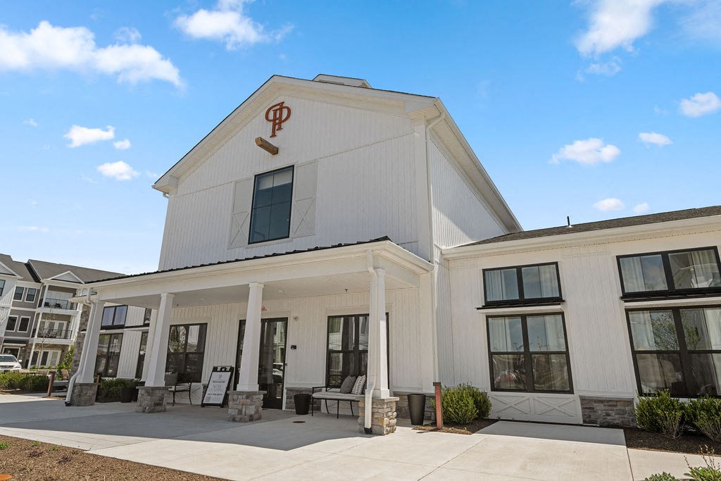 the building where the hotel is located has a white building with windows and a porch at Madison Prickett Preserve, Pennsylvania