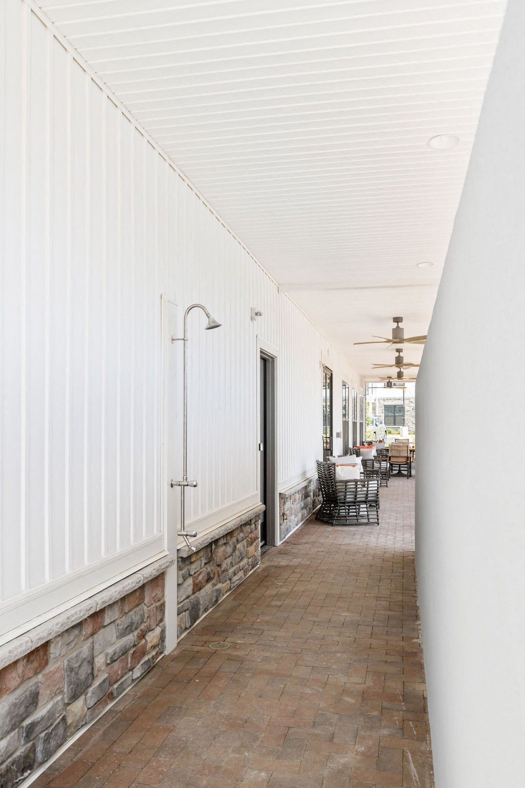 A long hallway with a brick floor and white walls at Madison Prickett Preserve, Yardley, 19067