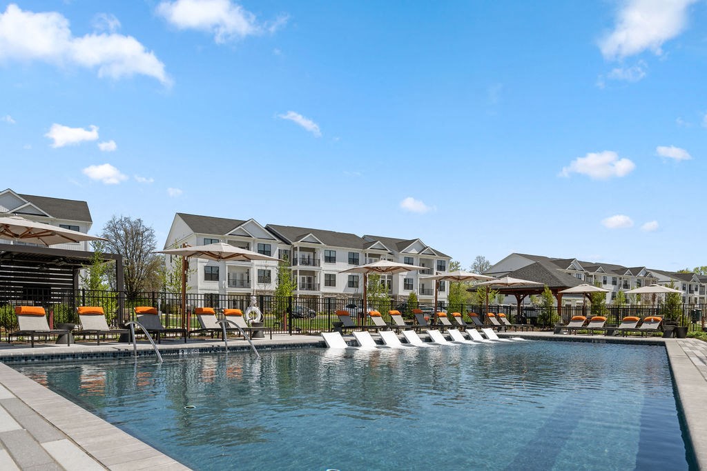 A large swimming pool with lounge chairs and a resort-style building in the background at Madison Prickett Preserve, Yardley, PA