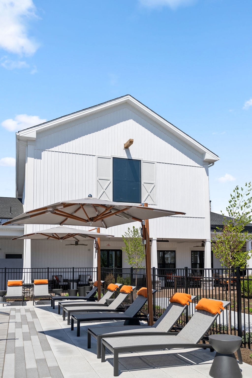 a patio with tables and chairs outside of a white building at Madison Prickett Preserve, Yardley, PA