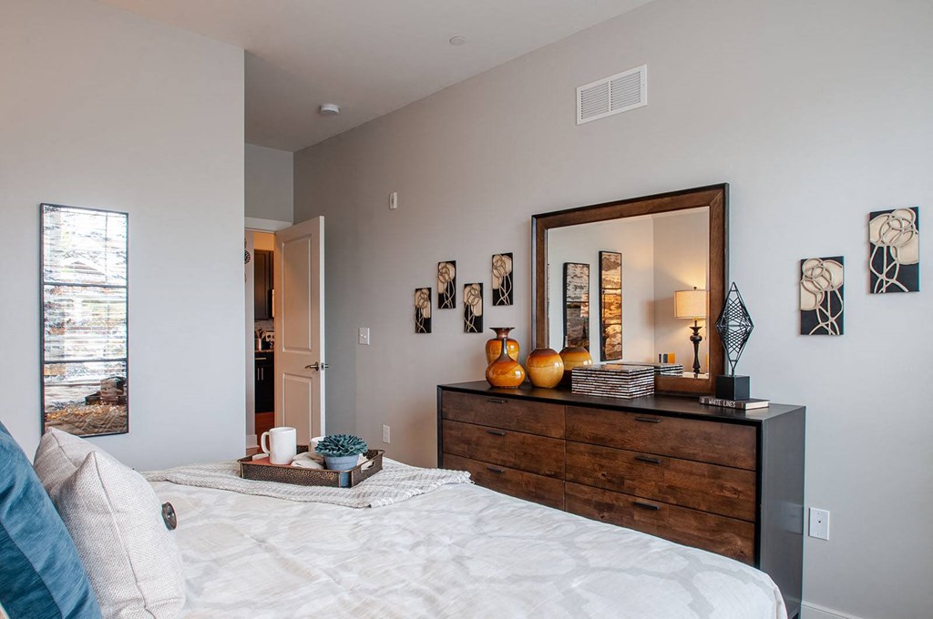 a bedroom with a large bed and a large mirror  at Madison Providence, Pennsylvania