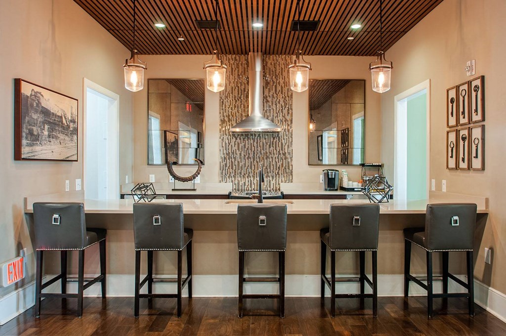 a kitchen with a long island with four stools in front of it  at Madison Providence, Collegeville, Pennsylvania