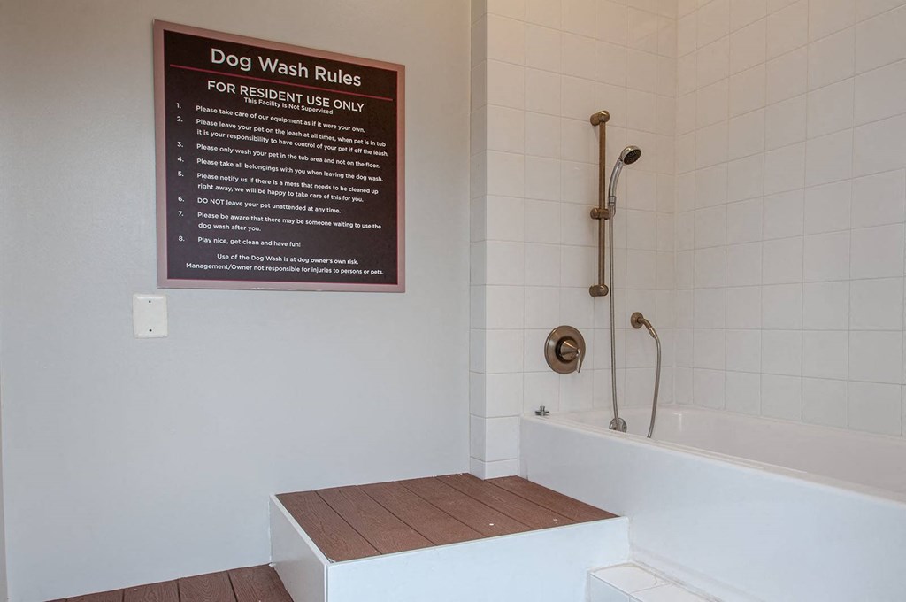 a bathroom with a bathtub and a sign on the wall that says dog wash rules  at Madison Providence, Collegeville, PA